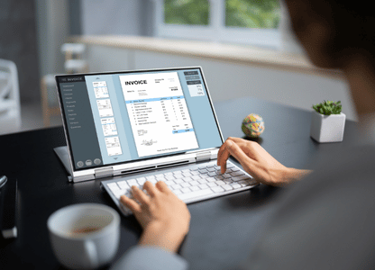 A person typing into their laptop